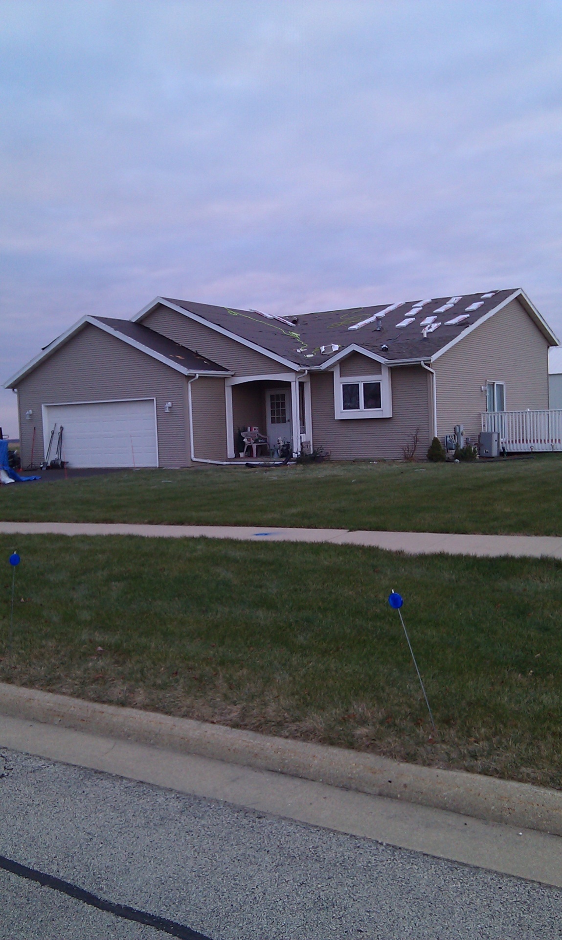 Home with shingle bundles staged on the roof deck before installation
